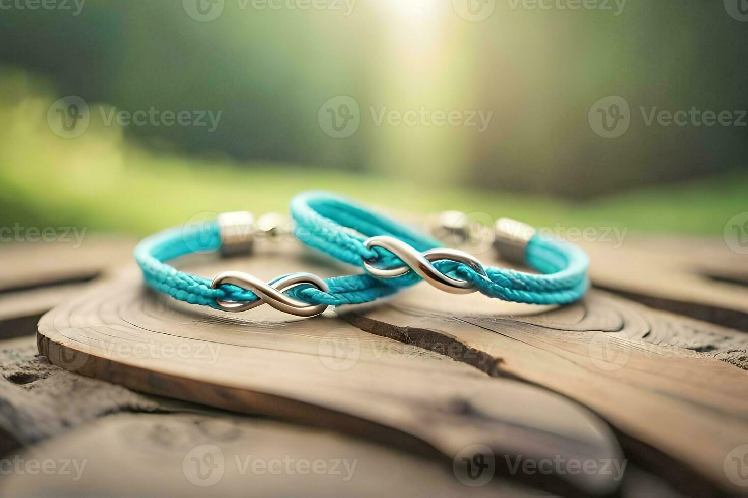 a close up photograph of a pair blue bracelet forming an infinity symbol on a rustic wood with bokeh background photo