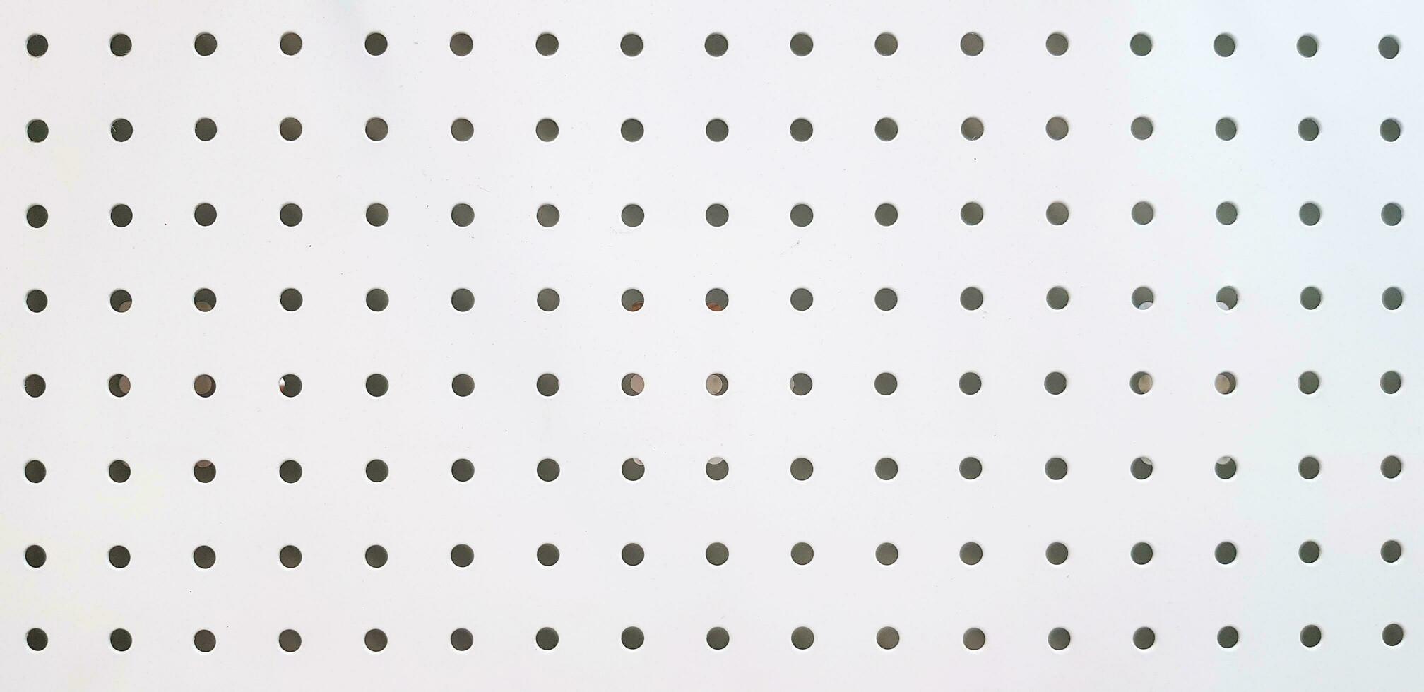 Seamless pattern of polka dot on white stainless steel for background. Art Wallpaper and Textured concept. photo