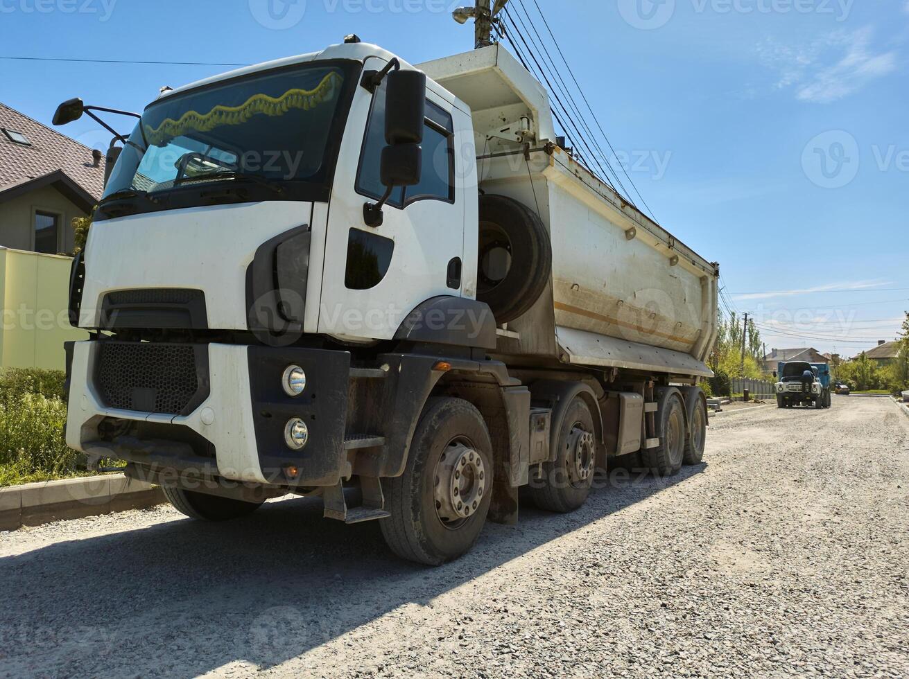 A truck carrying construction sand or concrete. The concept of reloading on the roads and renting a dump truck for work photo