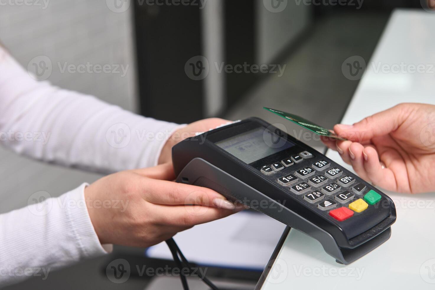 Selective focus on POS terminal, credit card reader in the hands holding it out for cashless payment view NFC technology photo