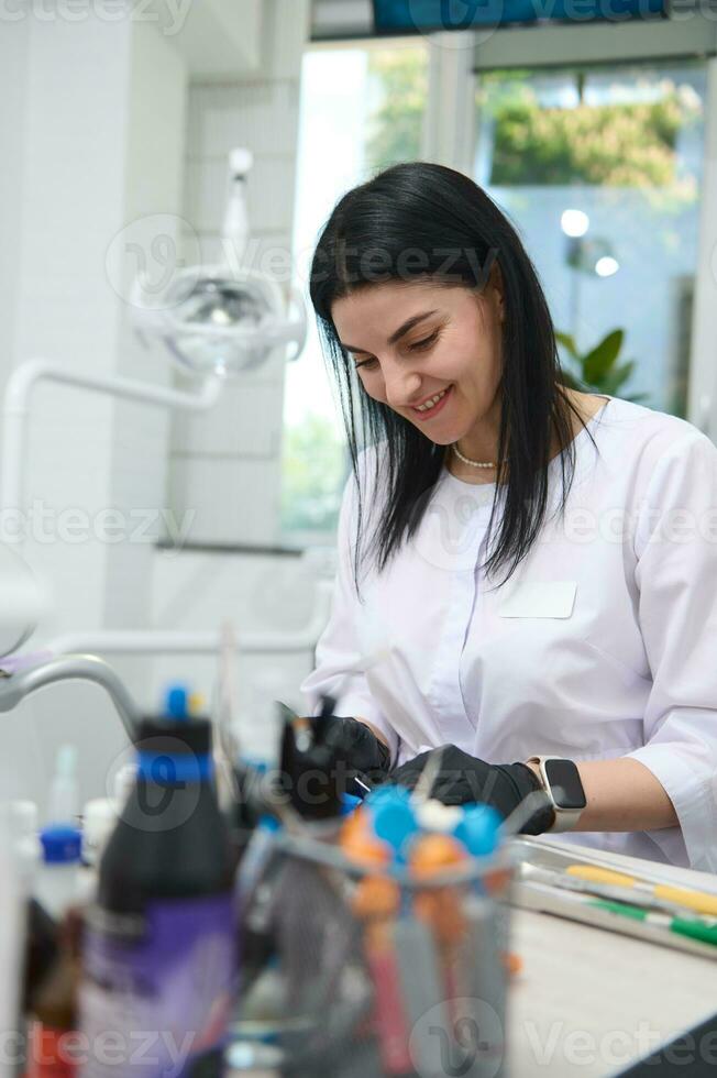 Professional dentist, dental technician, prosthetic engineer working with gypsum mold of human jaw in dental medical lab photo