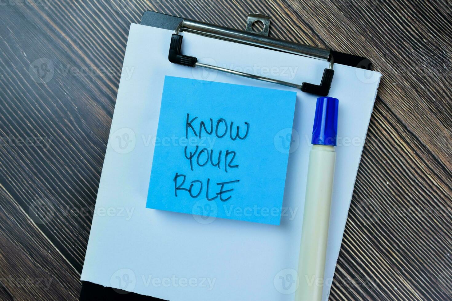 Concept of Know Your Role write on sticky notes isolated on Wooden Table. photo