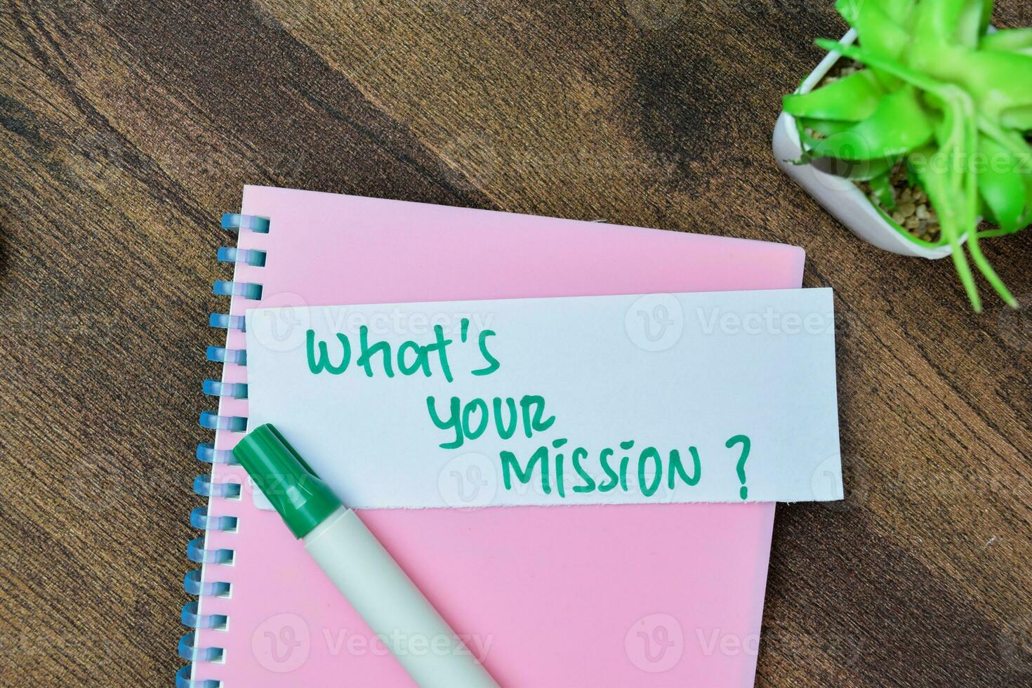 Concept of What's Your Mission write on sticky notes isolated on Wooden Table. photo