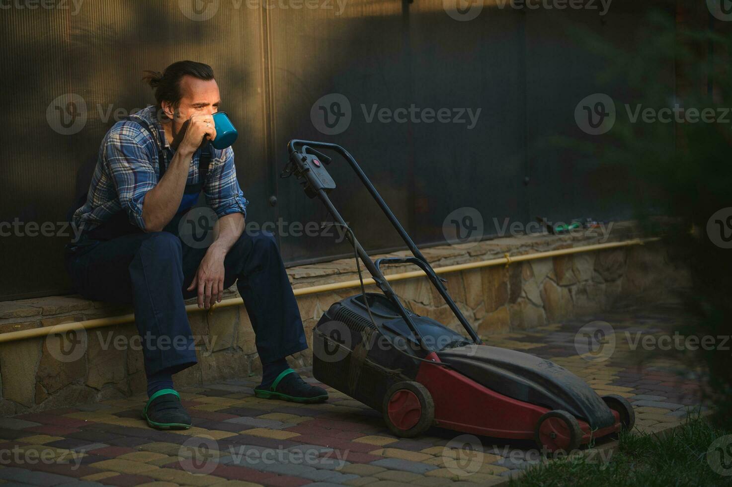 Overworked homeowner gardener amateur drinks coffee, takes break after hard day's work. People Labour Hobby Occupation photo