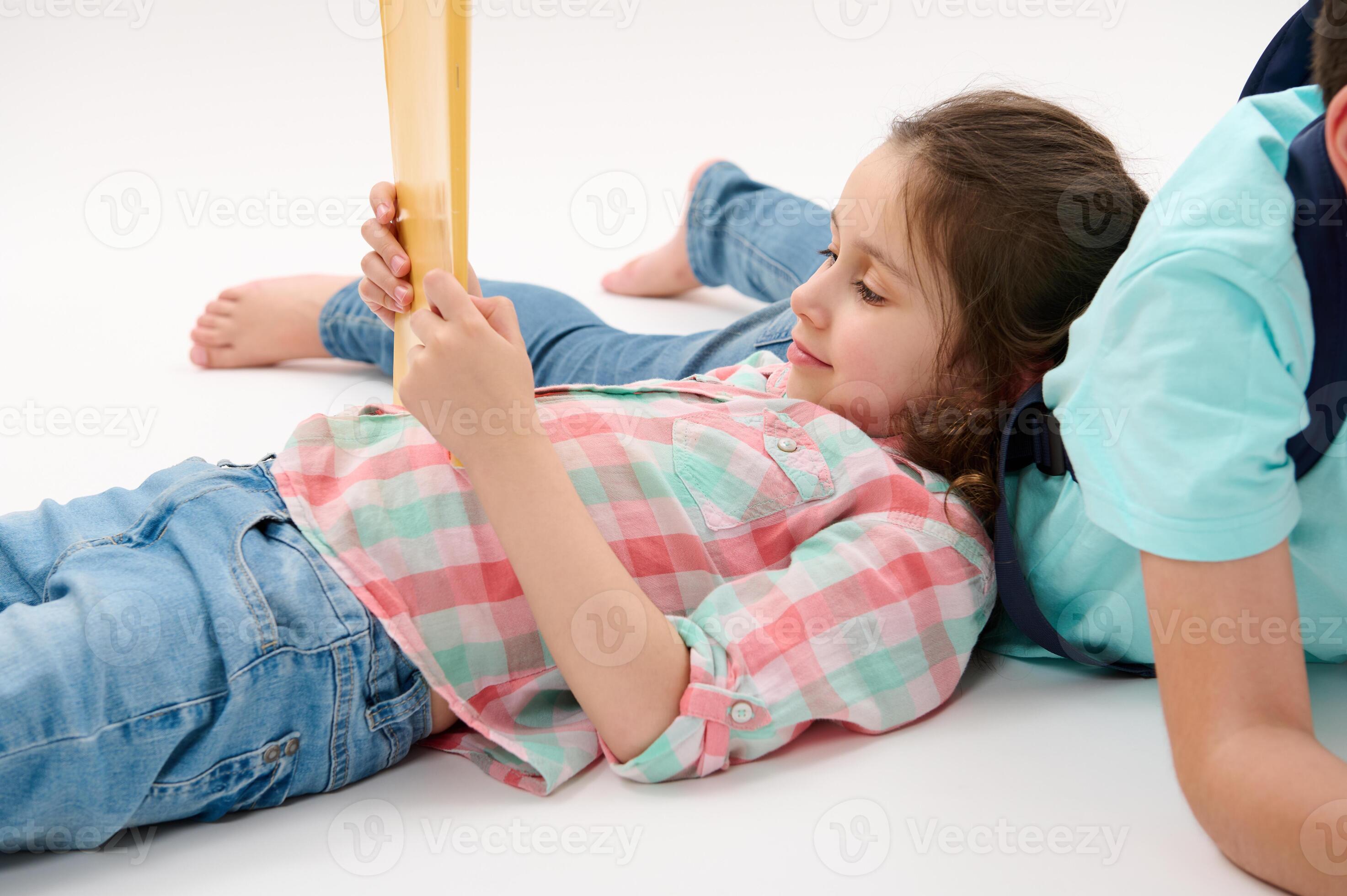6 yo girl Little girl 6 y.o, first grader, primary school student in plaid shirt and  blue jeans, holding textbook, white backdrop 25912688 Stock Photo at  Vecteezy