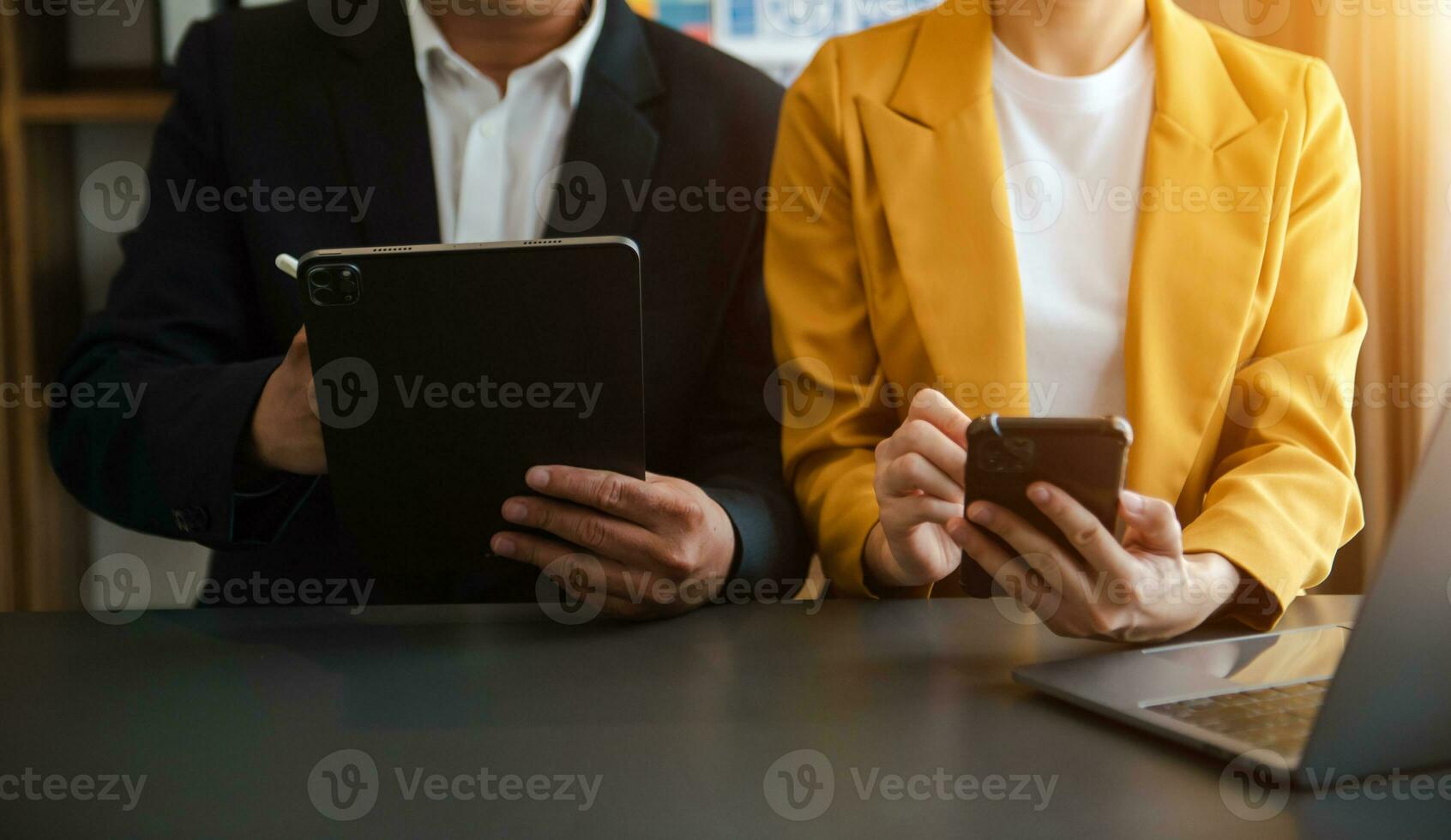 Business documents on office table with smart phone and calculator digital tablet and graph photo