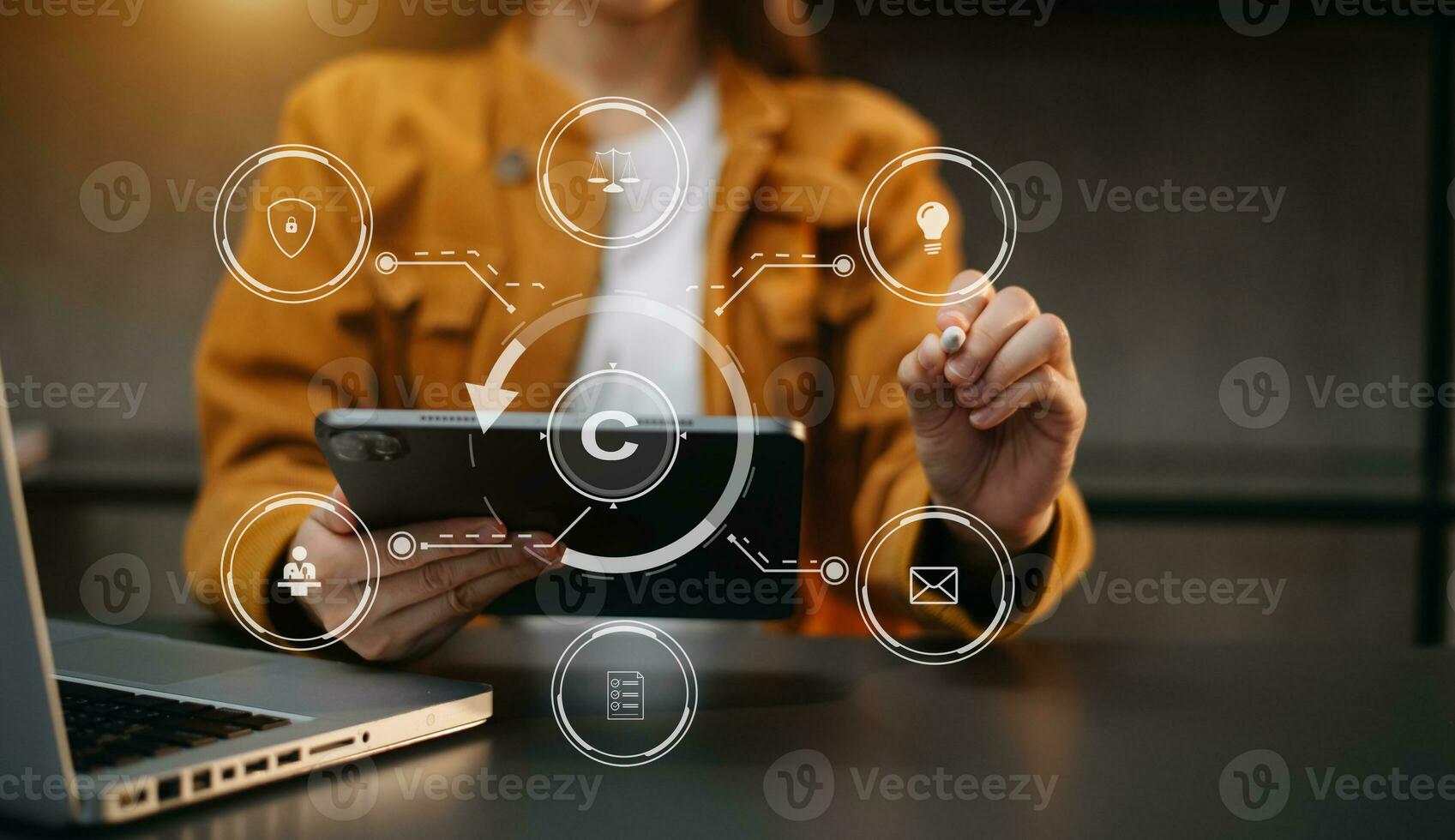 Copyright or patent concept, Person hand using laptop computer, tablet and smartphone with virtual screen copyright icon trademark, Creation ownership against piracy. photo