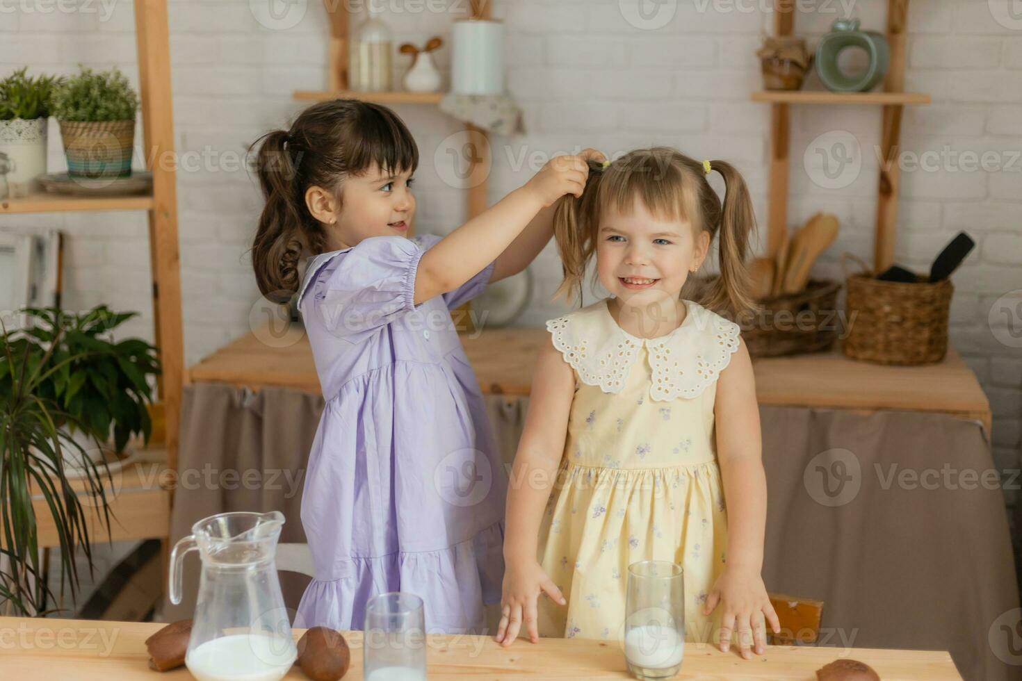 little happy girls fool around in the spring and cook in the kitchen photo