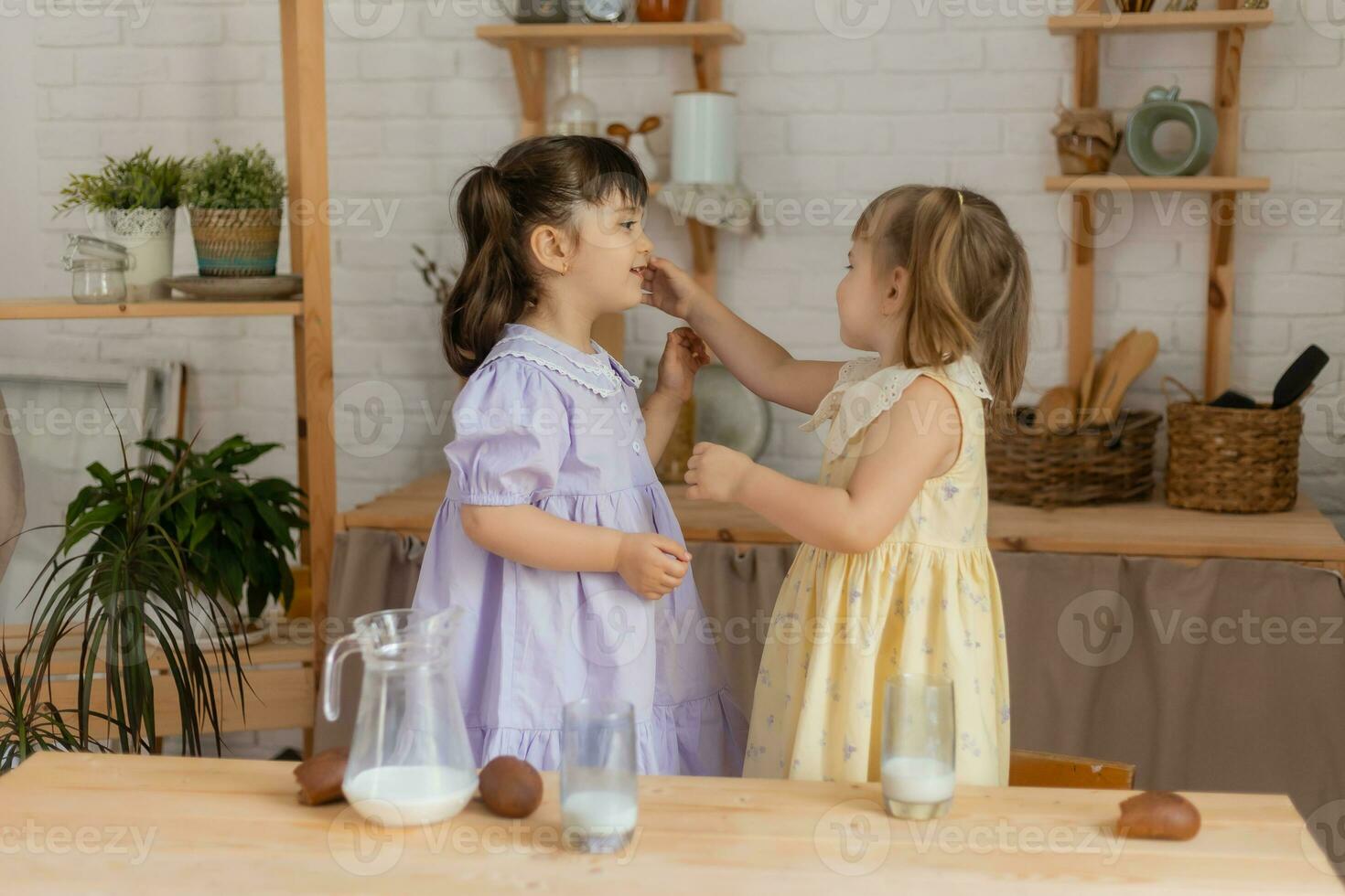 little happy girls fool around in the spring and cook in the kitchen photo