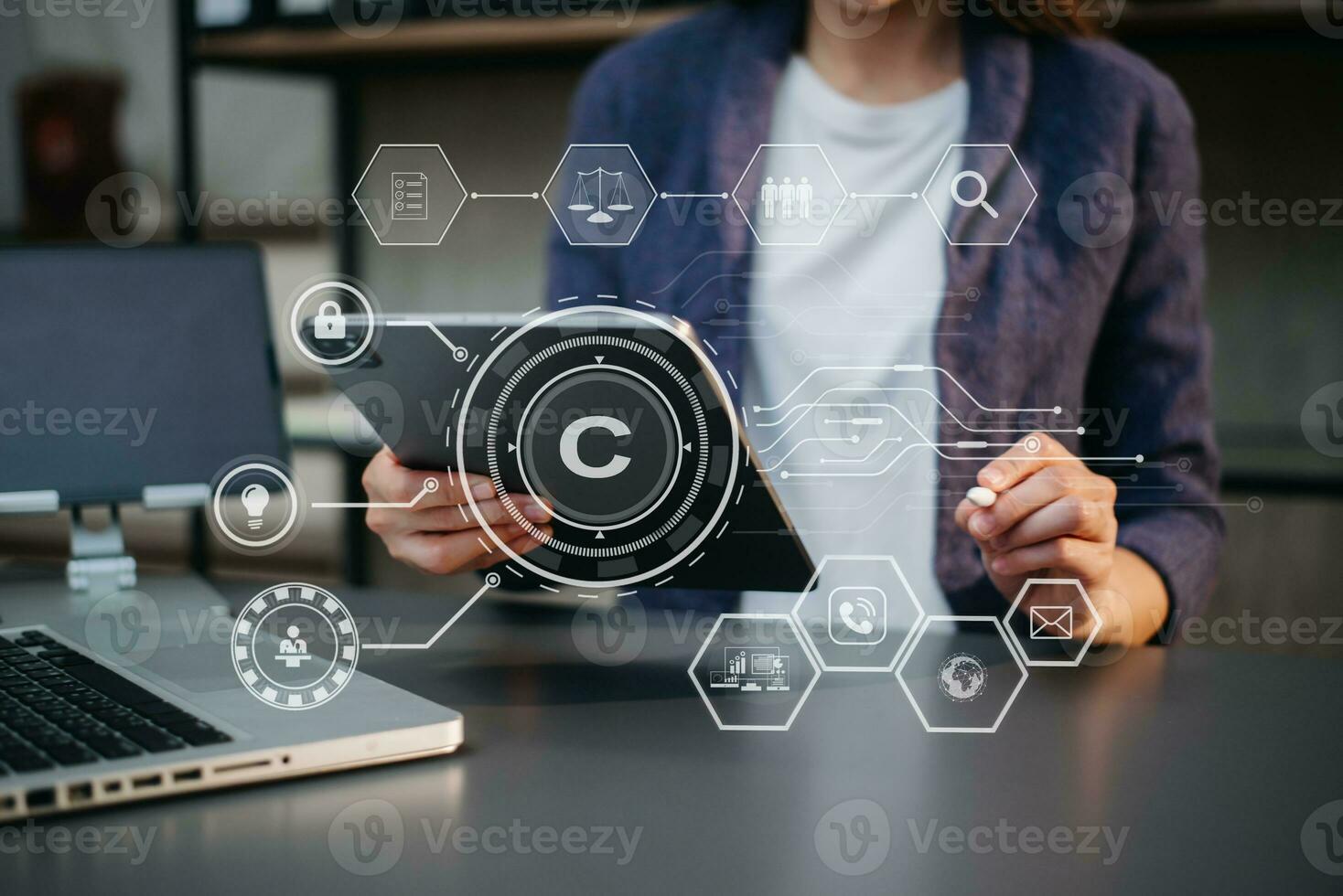 Copyright or patent concept, Person hand using laptop computer, tablet and smartphone with virtual screen copyright icon trademark, Creation ownership against piracy. photo