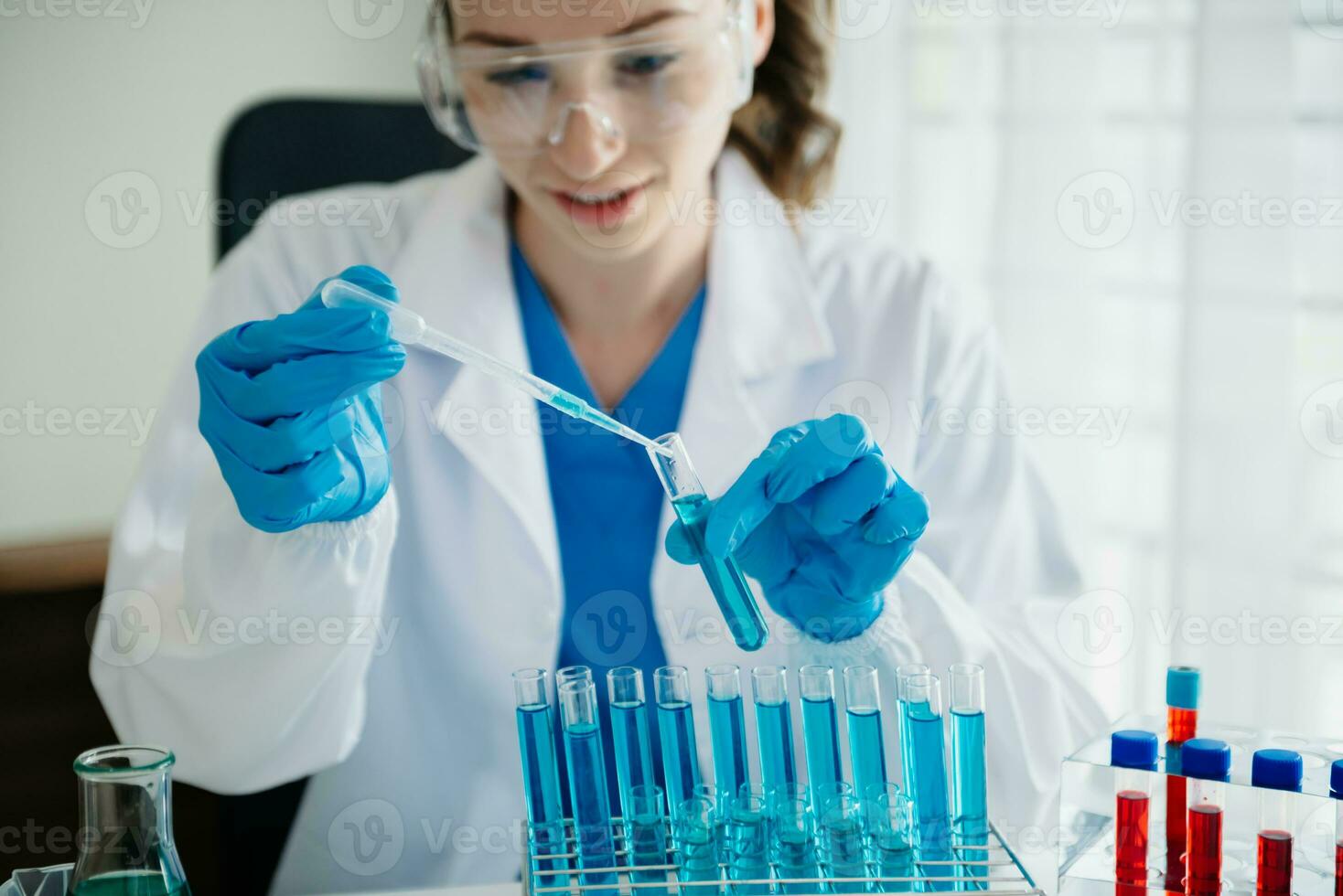 Modern medical research laboratory. female scientist working with micro pipettes analyzing biochemical samples, advanced science chemical laboratory for medicine. photo