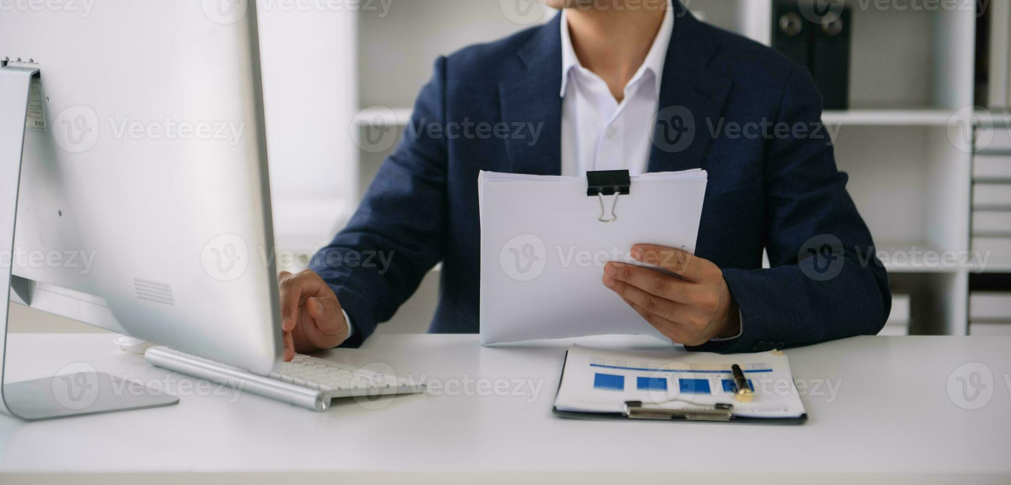 Business man working at office with laptop and documents on his desk new start up project. Finance task. photo