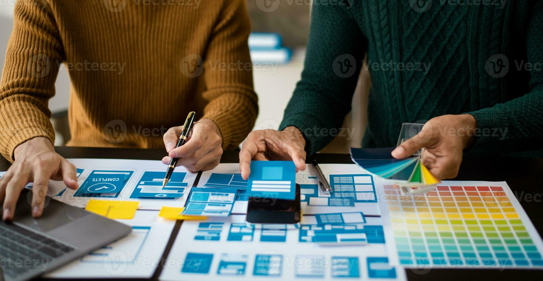 UI designer UX developer andbrainstorming about mobile app interface wireframe design with customer breif and color code. photo