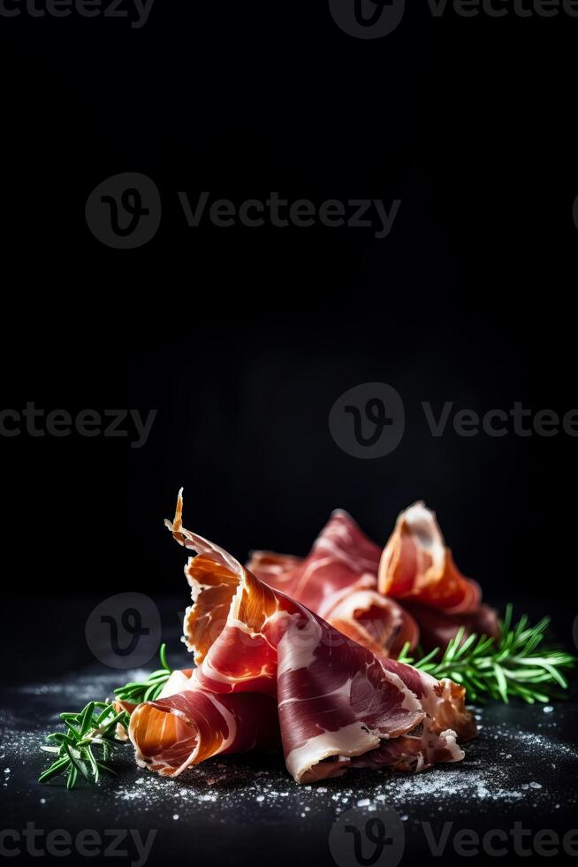 Spanish Jamon ham, prosciutto closeup isolated on black background copy space, photo