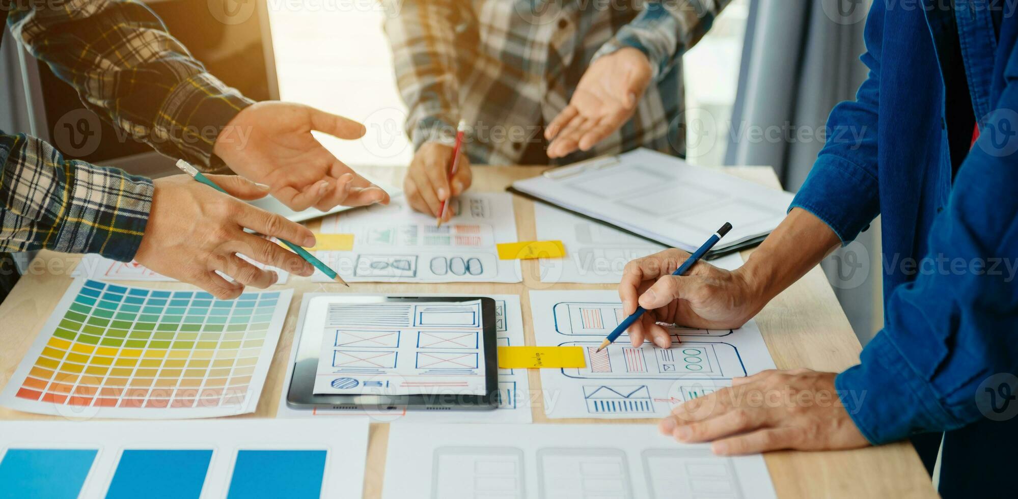 UX developer and ui designer brainstorming about mobile app interface wireframe design with customer breif and color code at modern office. photo