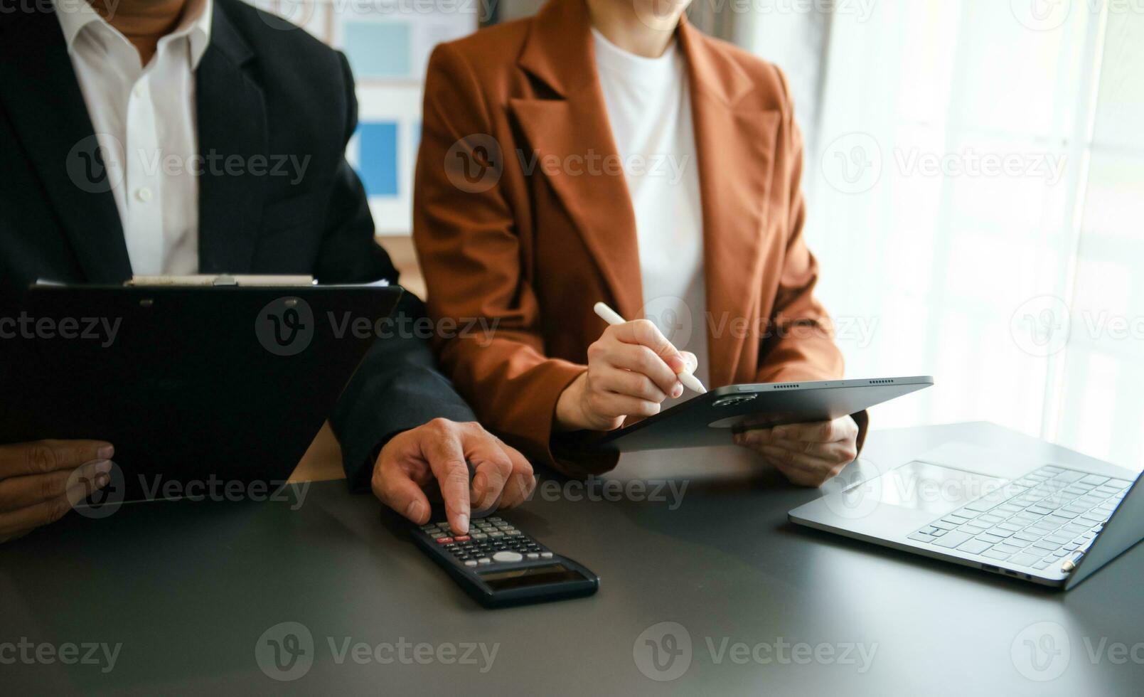 Business documents on office table with smart phone and calculator digital tablet and graph photo