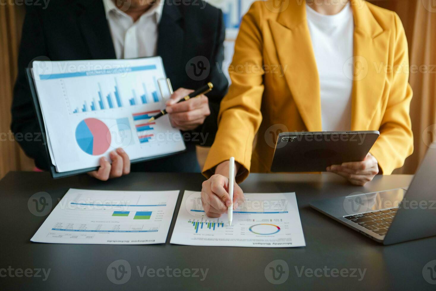 Business documents on office table with smart phone and calculator digital tablet and graph photo