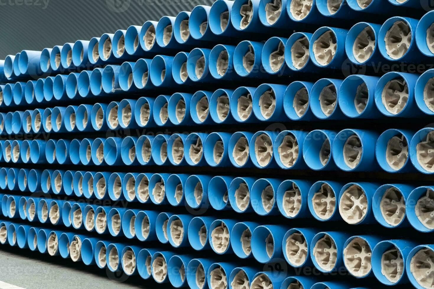 Blue Steel pipe , Spiral Welded pipe , High-quality weld steel pipes or Underground Pipe in stack waiting for shipment in warehouse. photo