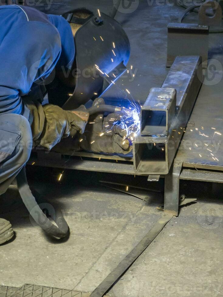 Welding Work with Equipment for Steel Metal, Iron, Sparks at Manufacturing Heavy Industry Factory, Indoor photo