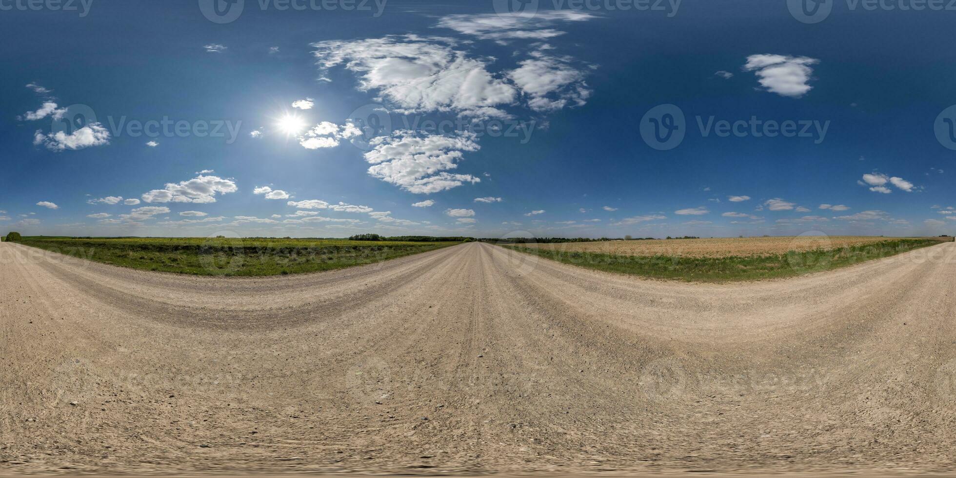 360 hdri panorama on gravel road with clouds on blue sky in equirectangular spherical  seamless projection, use as sky replacement in drone panoramas, game development as sky dome or VR content photo