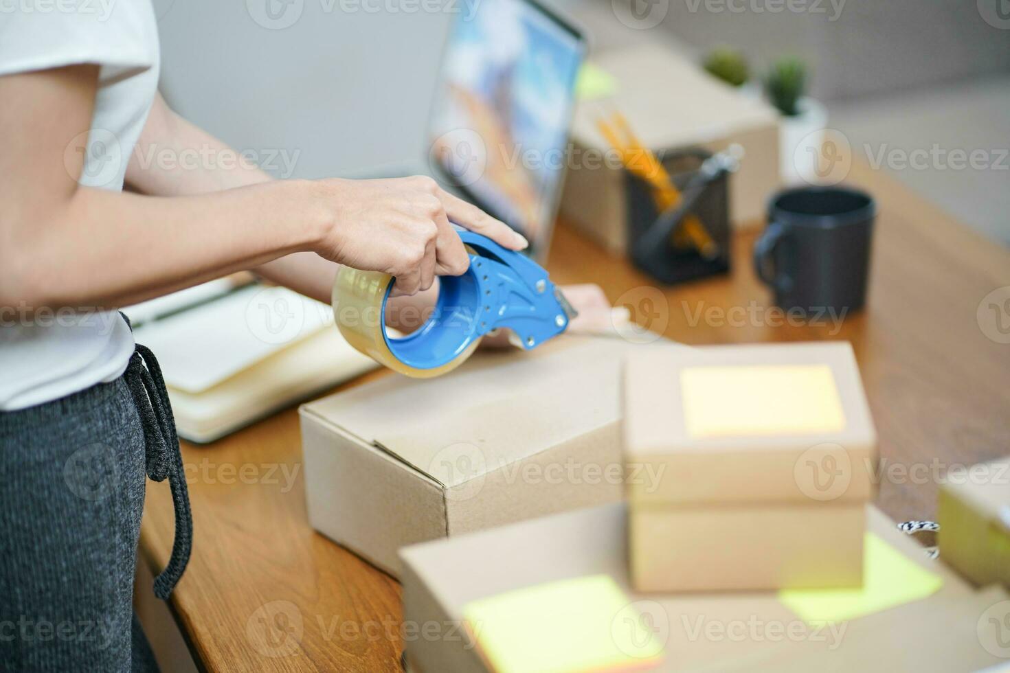 Business From Home Asian woman preparing package delivery box Shipping for shopping online. young start up small business owner at home online order photo