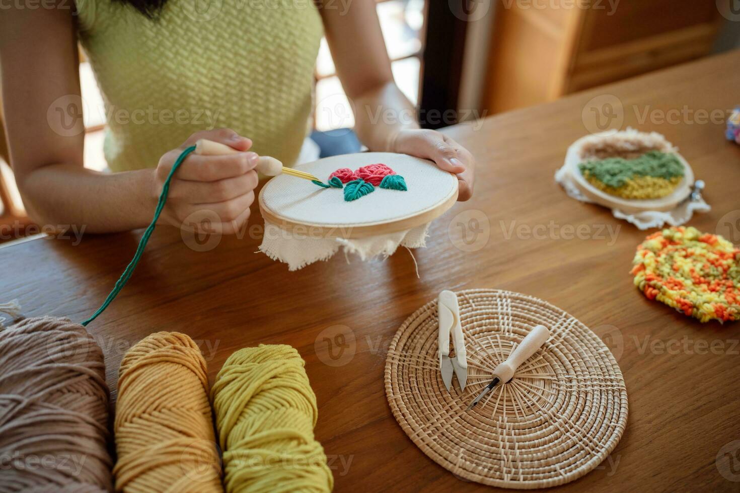 Punch needle. Asian Woman making handmade Hobby knitting in studio workshop. designer workplace Handmade craft project DIY embroidery concept. photo