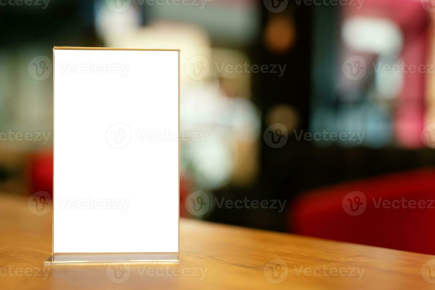 Mock up Menu frame standing on wood table in Bar restaurant cafe. space for text photo