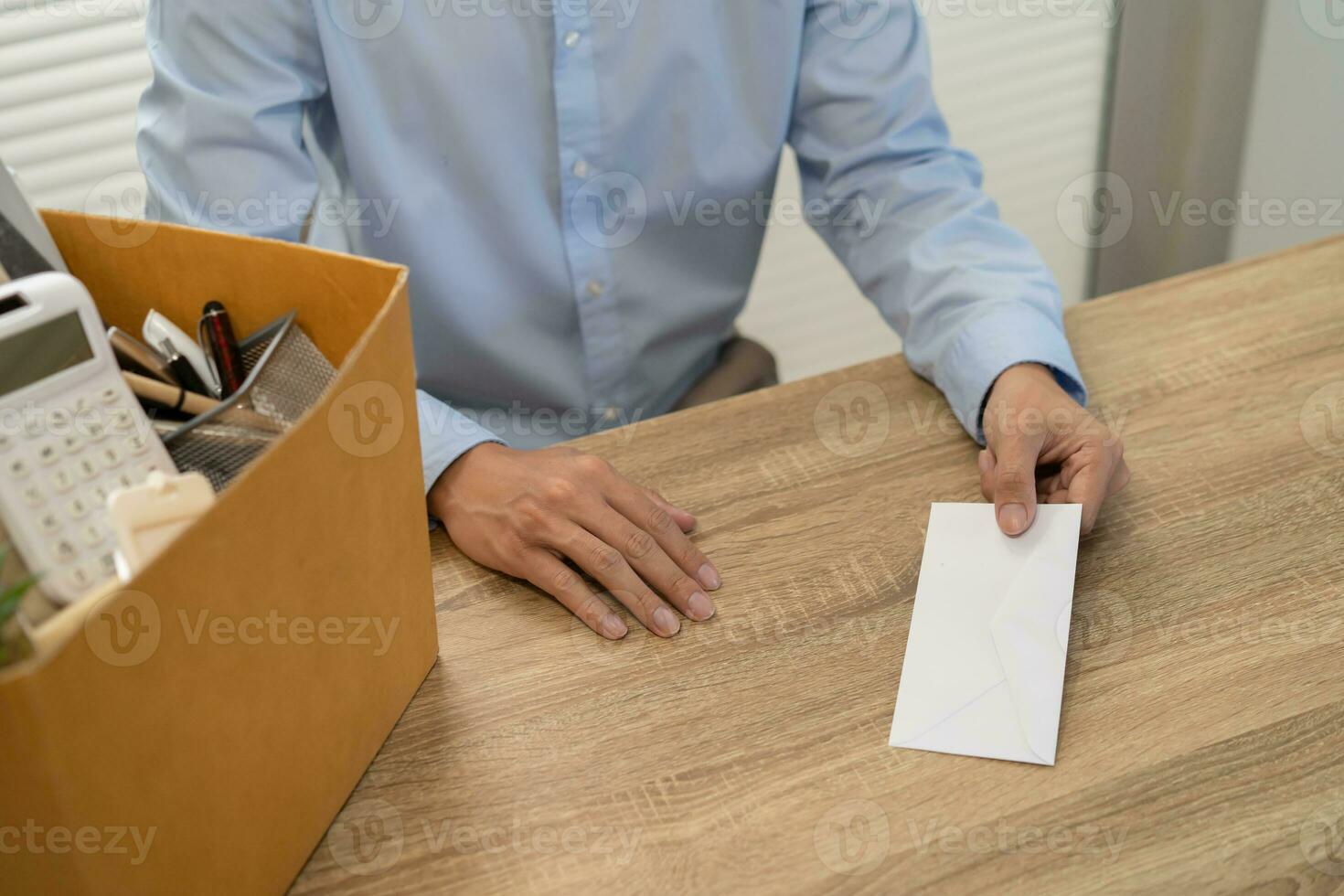 sending resignation letter to boss and Holding Stuff Resign Depress or carrying cardboard box by desk in office photo