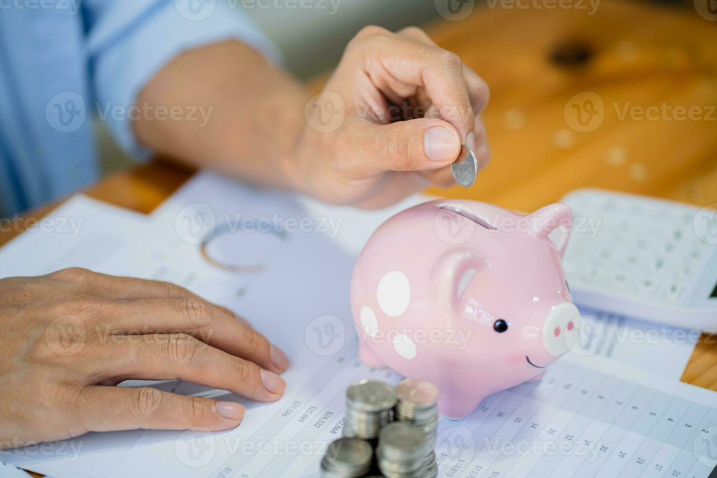 Saving money. Businessman Accountant verify growing business and saving money stacking coins with calculator. Accountancy Concept. photo