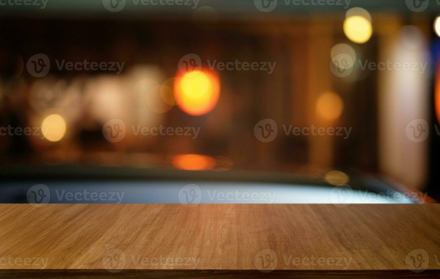 Empty dark wooden table in front of abstract blurred bokeh background of restaurant . can be used for display or montage your products.Mock up for space. photo