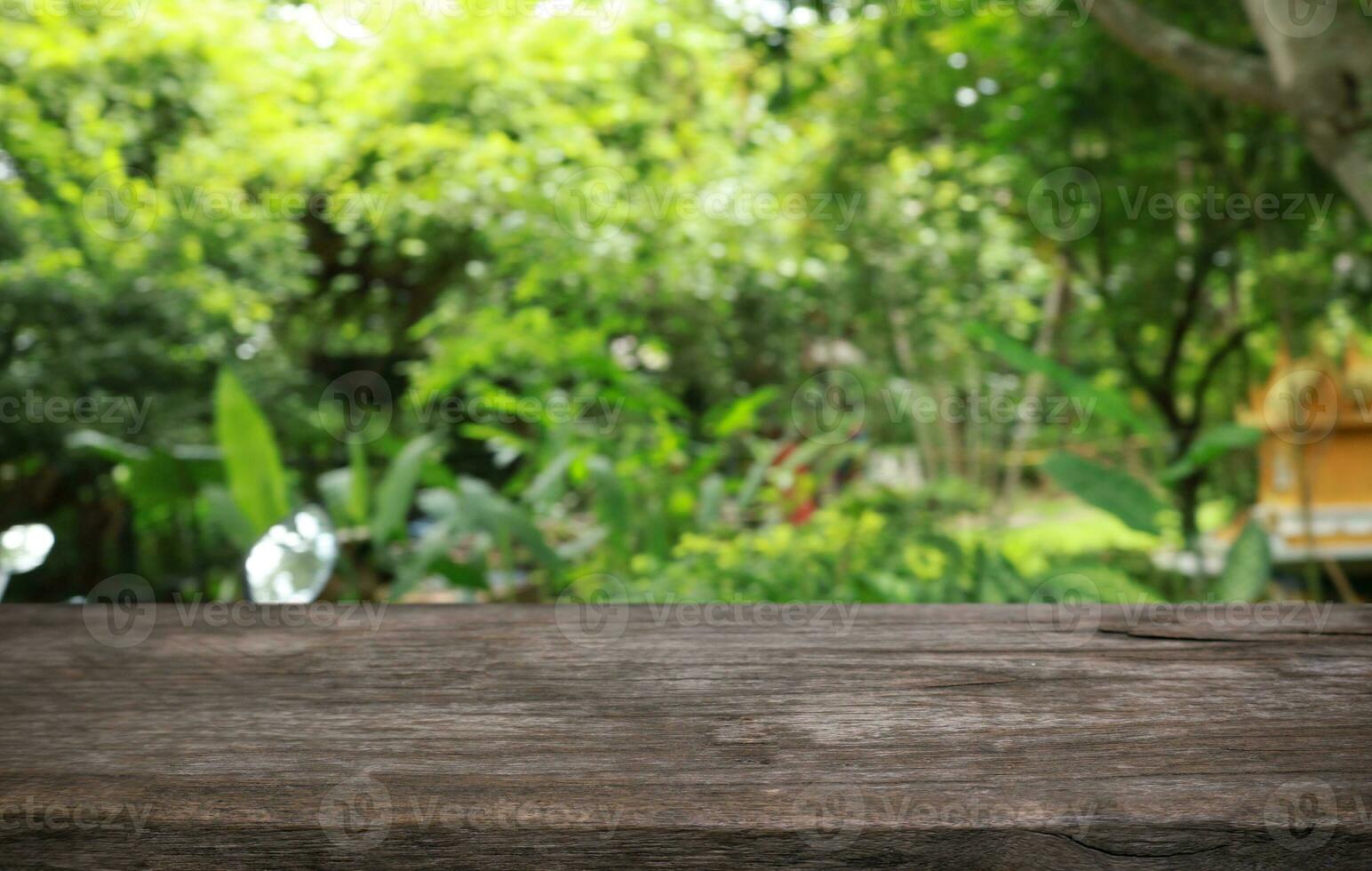 Empty wood table top and blur of out door garden background Empty wooden table space for text marketing promotion. blank wood table copy space photo