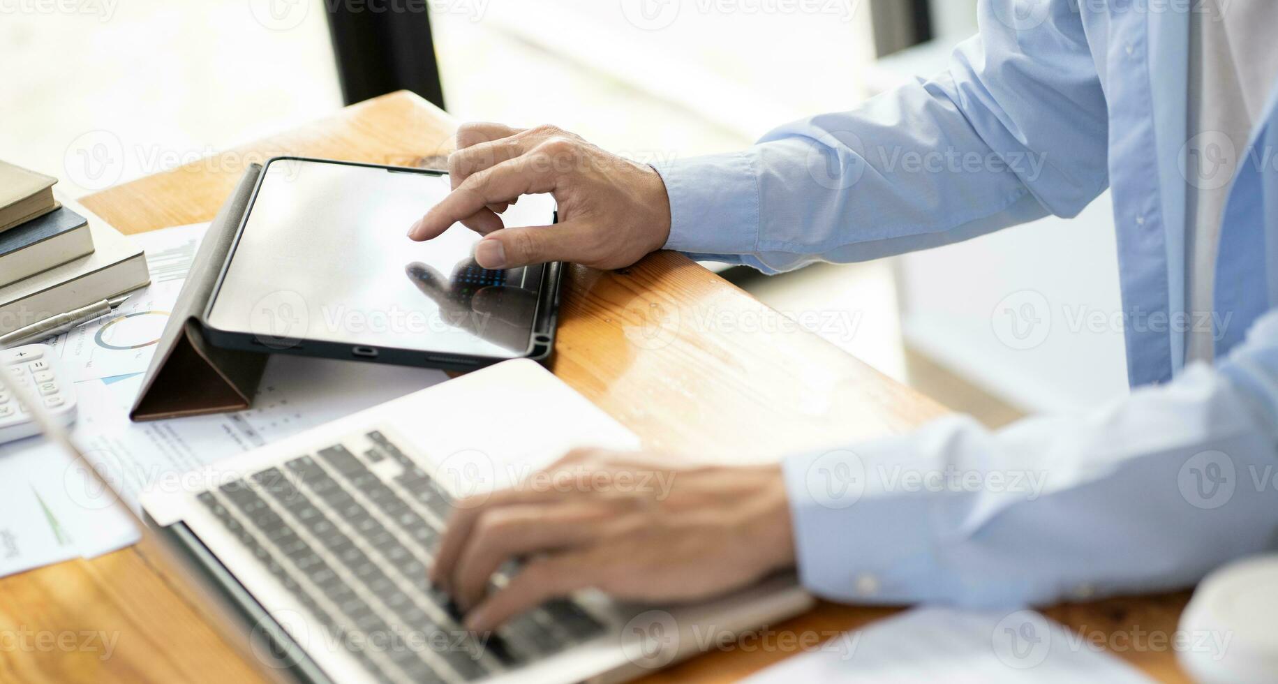Business man working by using laptop computer Hands typing on a keyboard. Professional investor working new start up project. business planning in office. Technology business Concept. photo