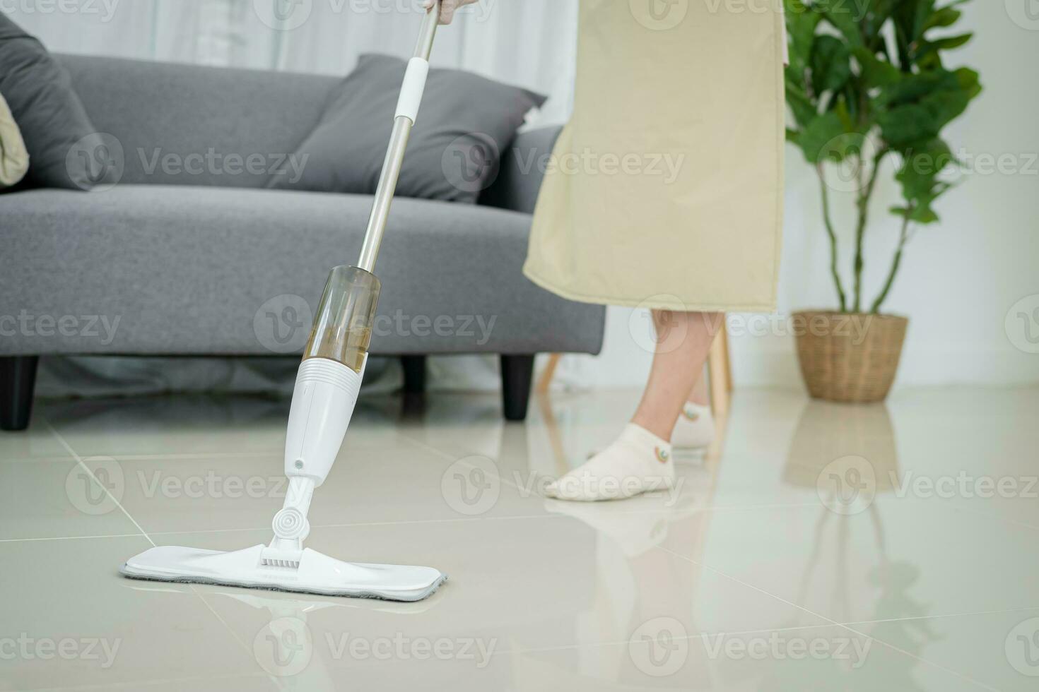 Attractive house wife Asian woman. beautiful successful woman cleaning living room . photo