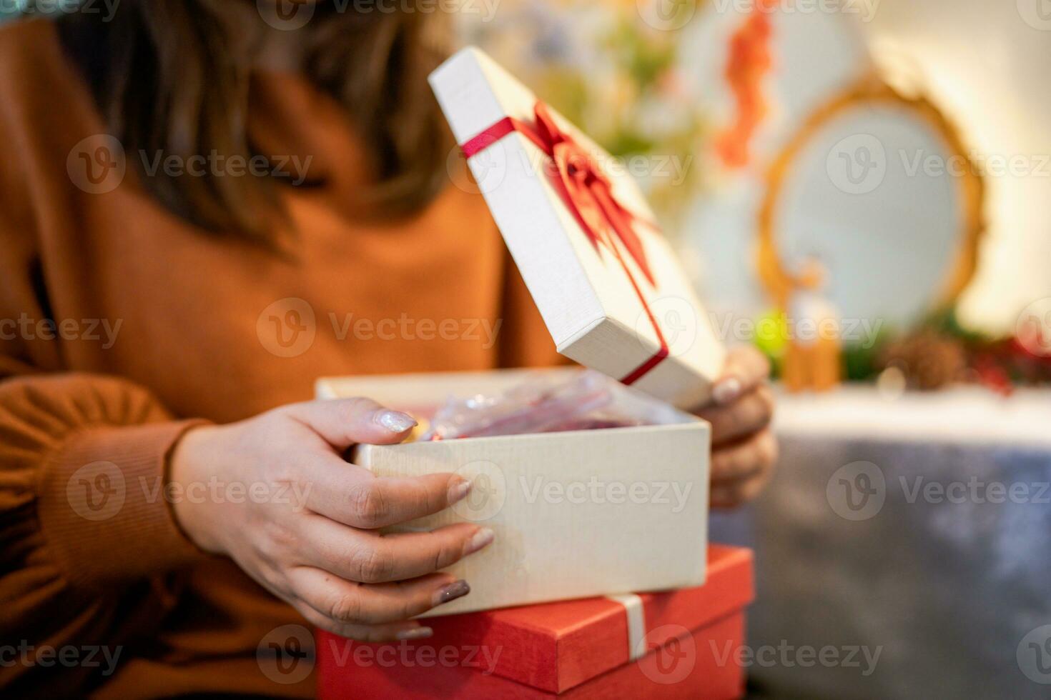 Happy asian woman open Christmas box and surprises. preparing surprise for xmas present in holiday photo
