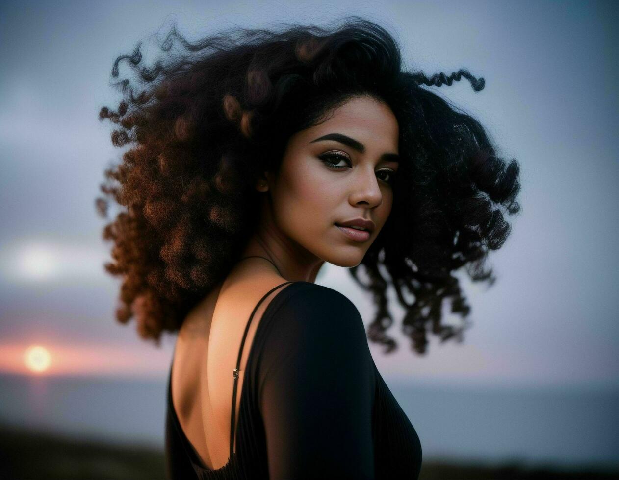 A beautiful brunette with curly hair wearing a light black top outdoors with the sun setting in the background, AI generated photo