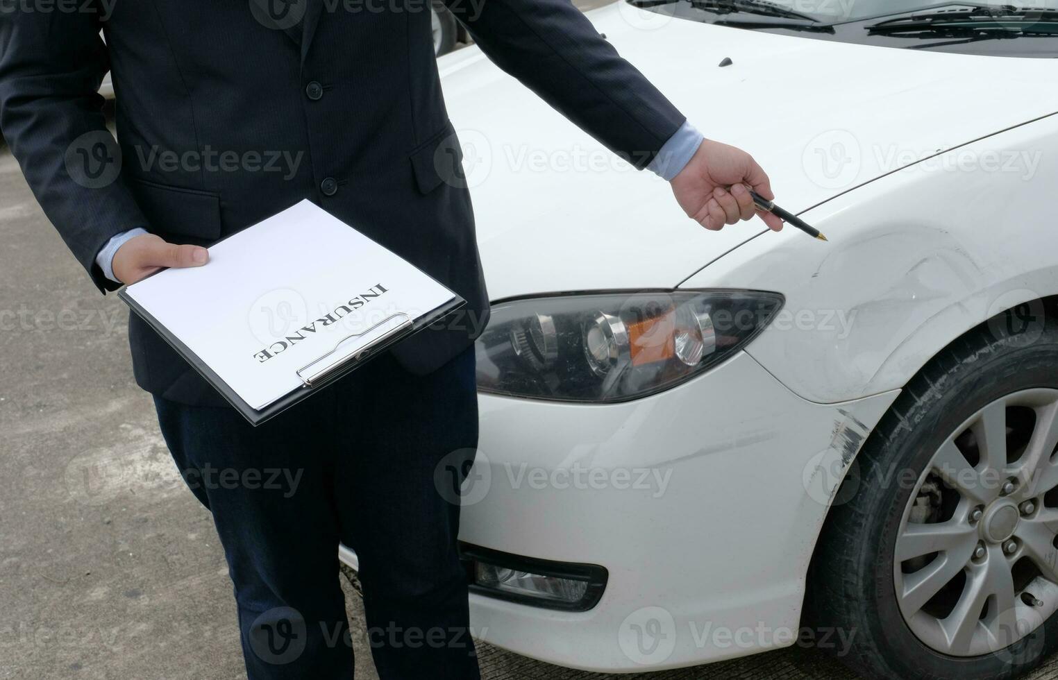 Loss Adjuster Insurance Agent Inspecting Damaged Car. photo