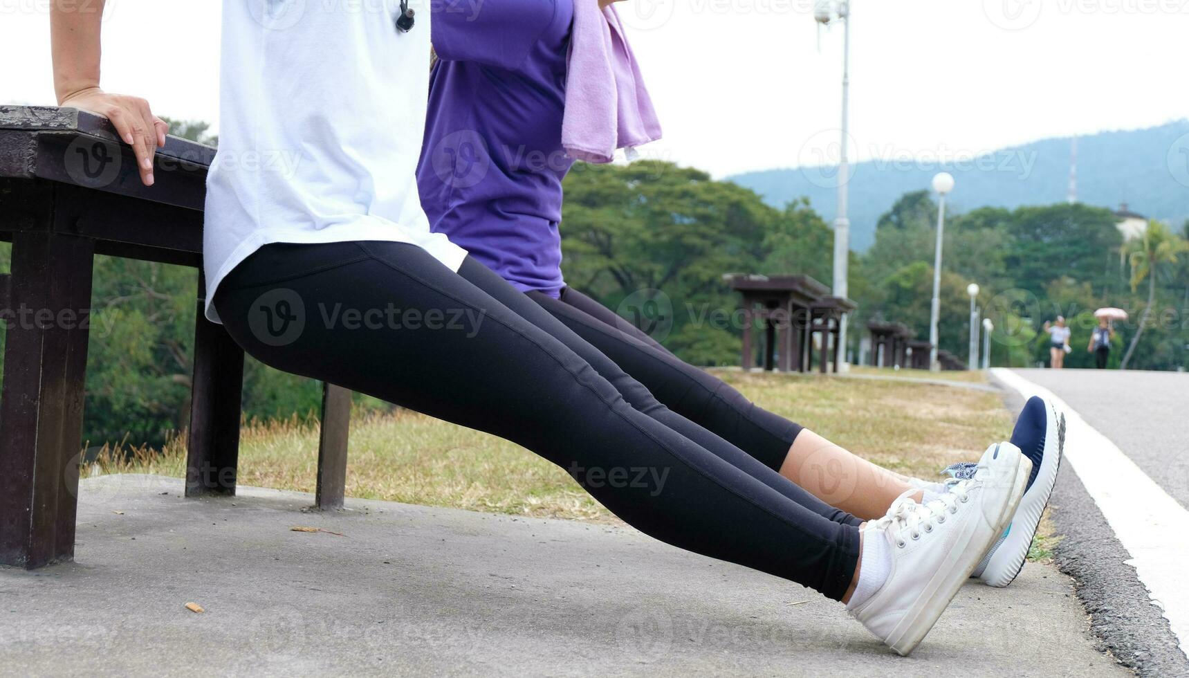 Young sporty woman workout before fitness training warming up in outdoors. photo