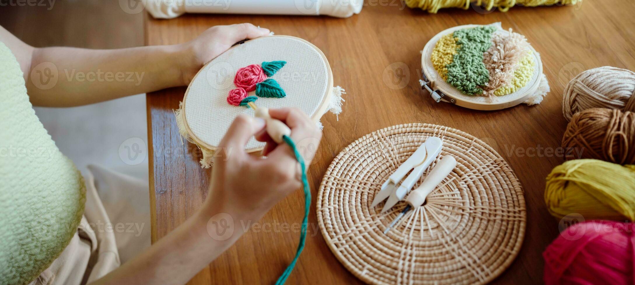 Punch needle. Asian Woman making handmade Hobby knitting in studio workshop. designer workplace Handmade craft project DIY embroidery concept. photo