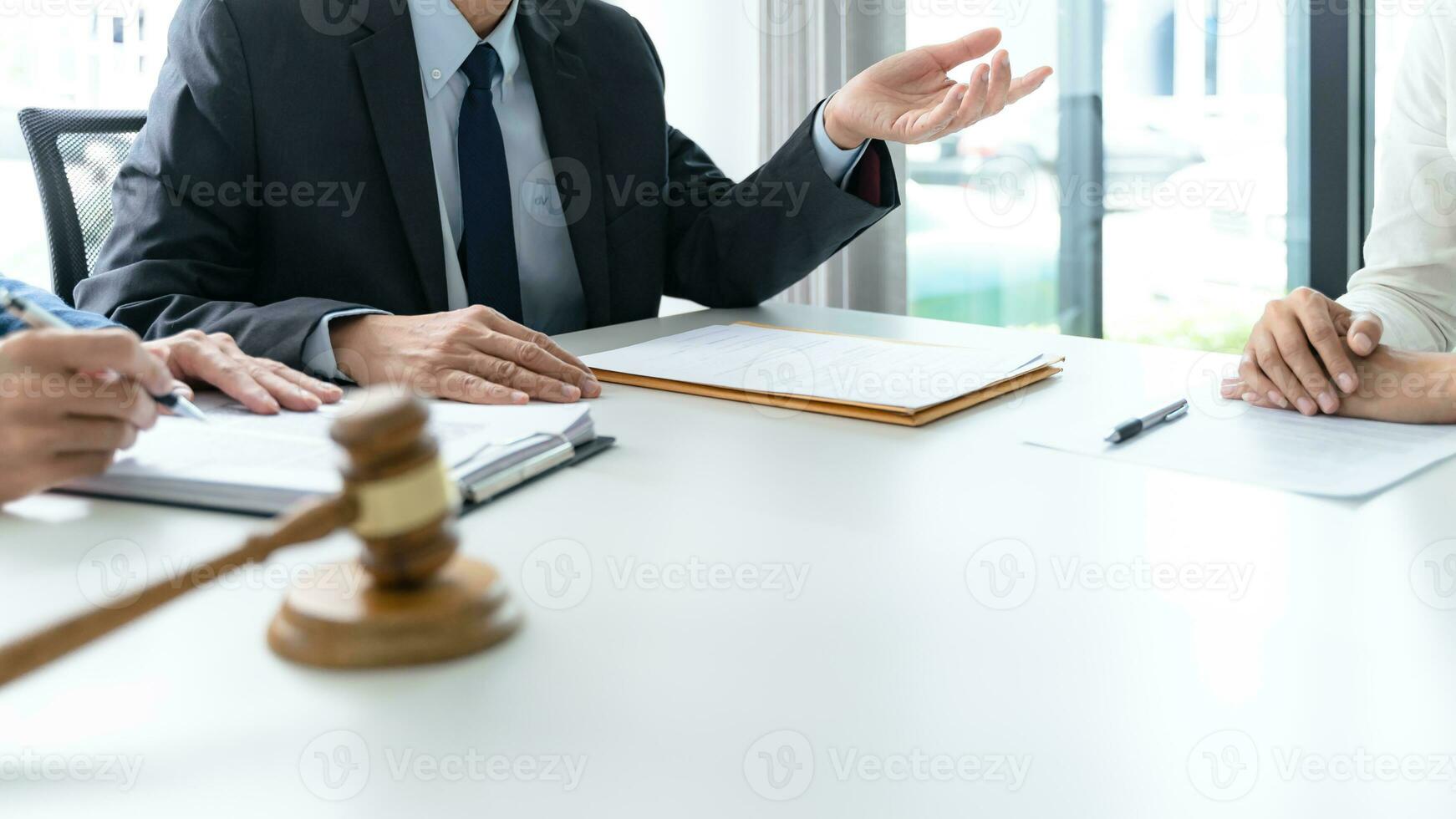 Legal counsel presents to the client a signed contract with gavel and legal law. justice and lawyer concept photo