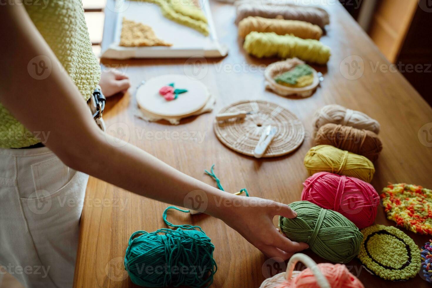 Punch needle. Asian Woman making handmade Hobby knitting in studio workshop. designer workplace Handmade craft project DIY embroidery concept. photo