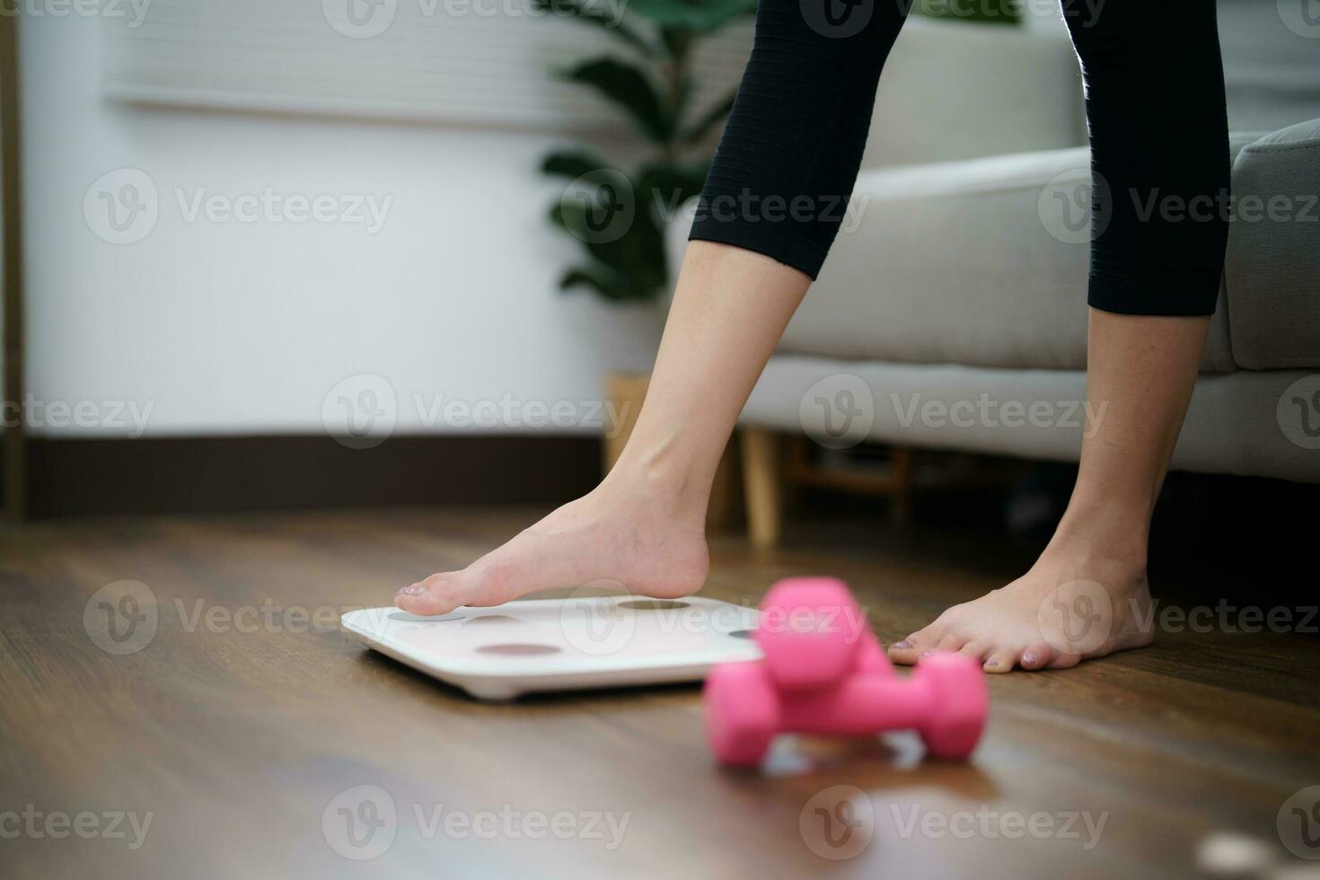 Fat diet and scale feet standing on electronic scales for weight control. Measurement instrument in kilogram for a diet control photo