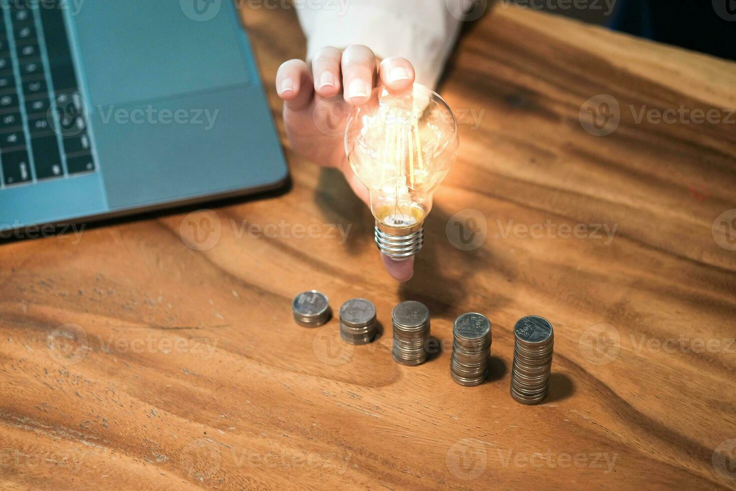 saving coins idea with light bulb for investment Concept idea and innovation. photo