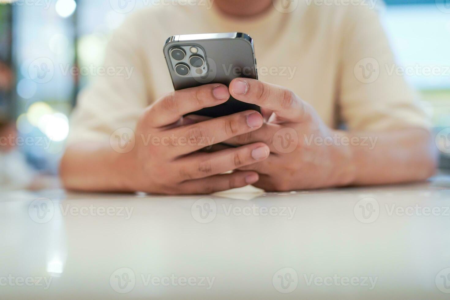 Relaxed young asian man using smart phone  spending time checking news social media. photo