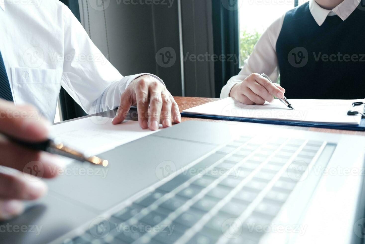 Businessman analyzing investment charts and pressing calculator buttons over documents. Accounting Concept. photo