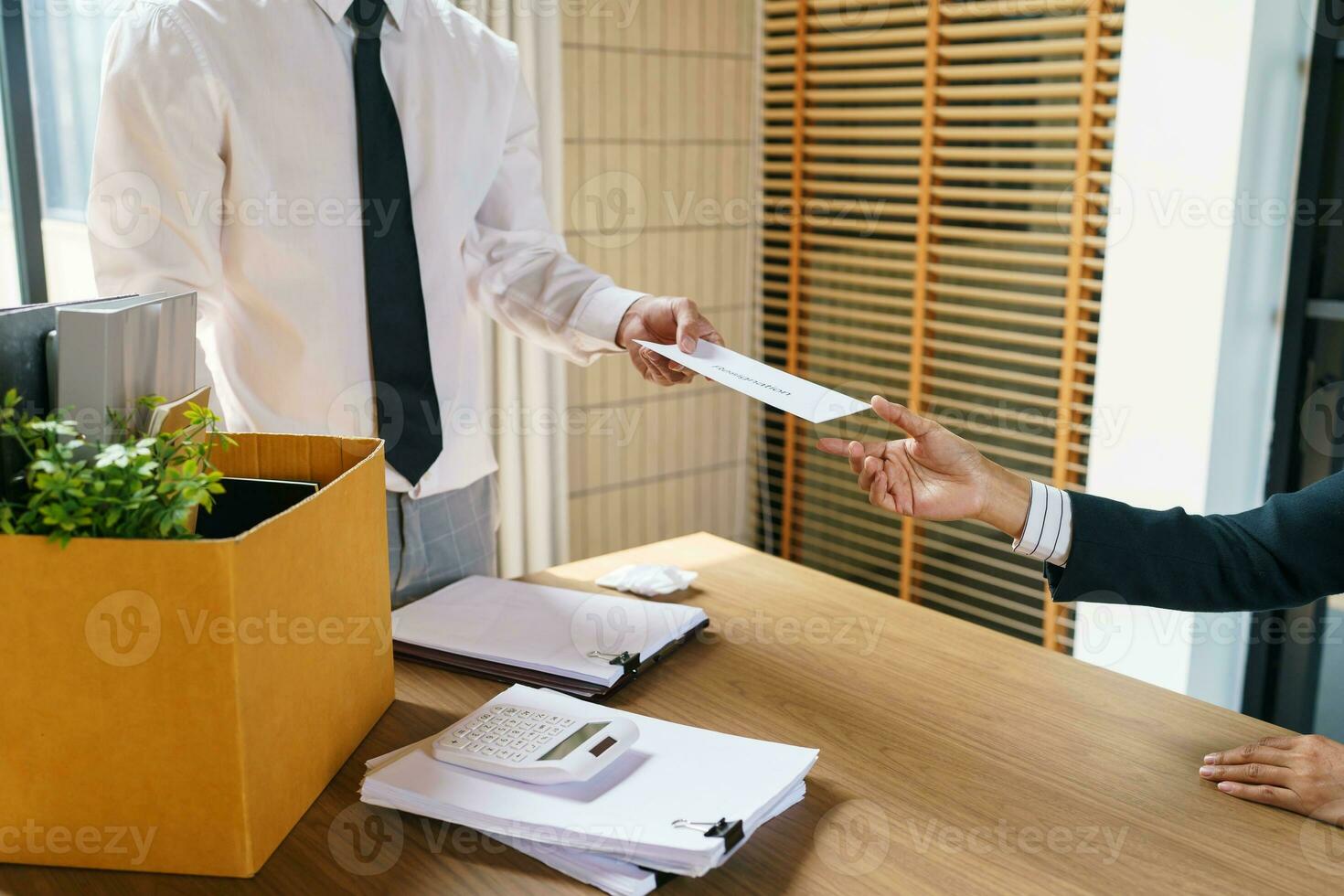Quit Job Business man sending resignation letter and packing Stuff Resign Depress or carrying business cardboard box in office. Change of job or fired from company. photo
