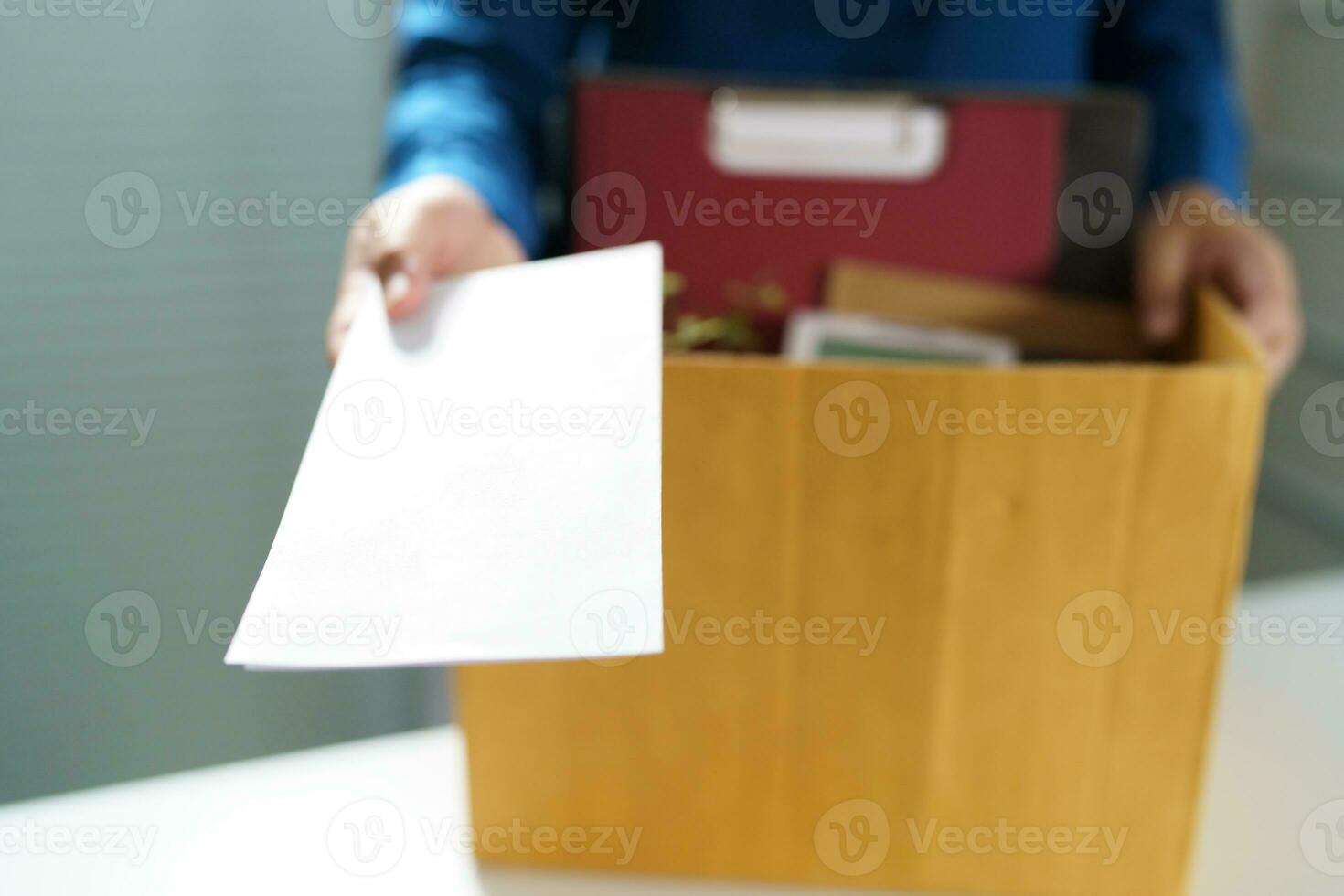 Quit Job Business man sending resignation letter and packing Stuff Resign Depress or carrying business cardboard box in office. Change of job or fired from company. photo