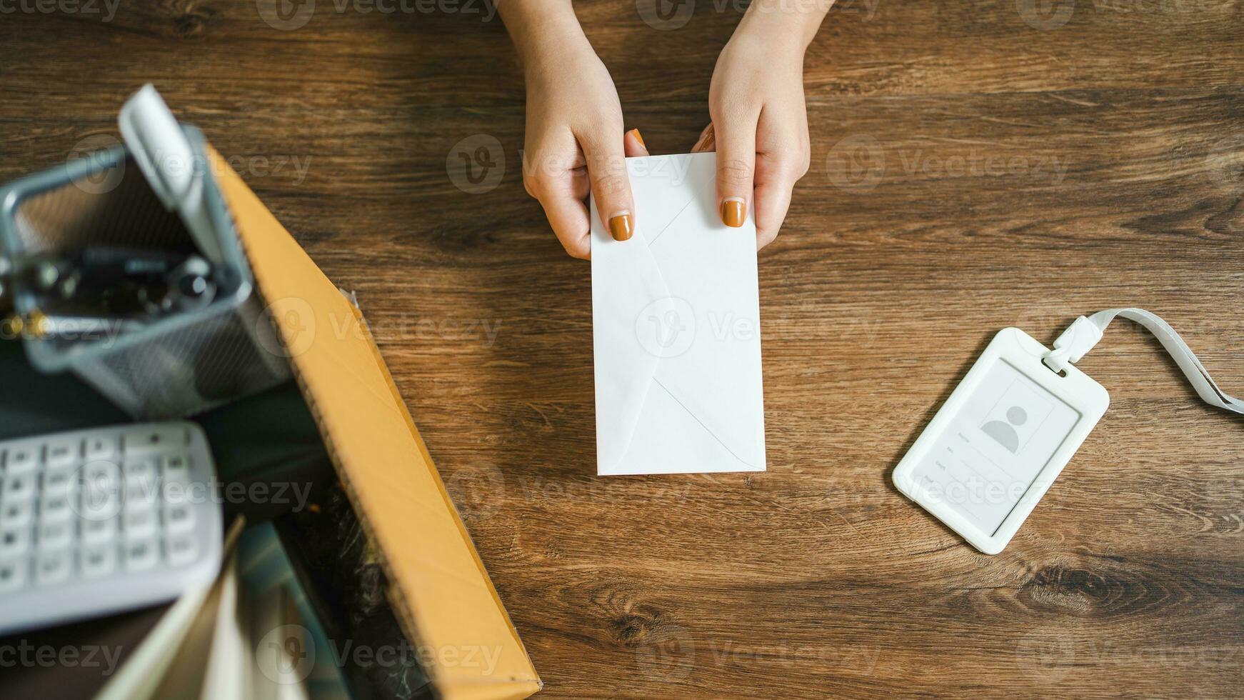 Business woman sending resignation letter and packing Stuff Resign Depress or carrying business cardboard box by desk in office. Change of job or fired from company photo