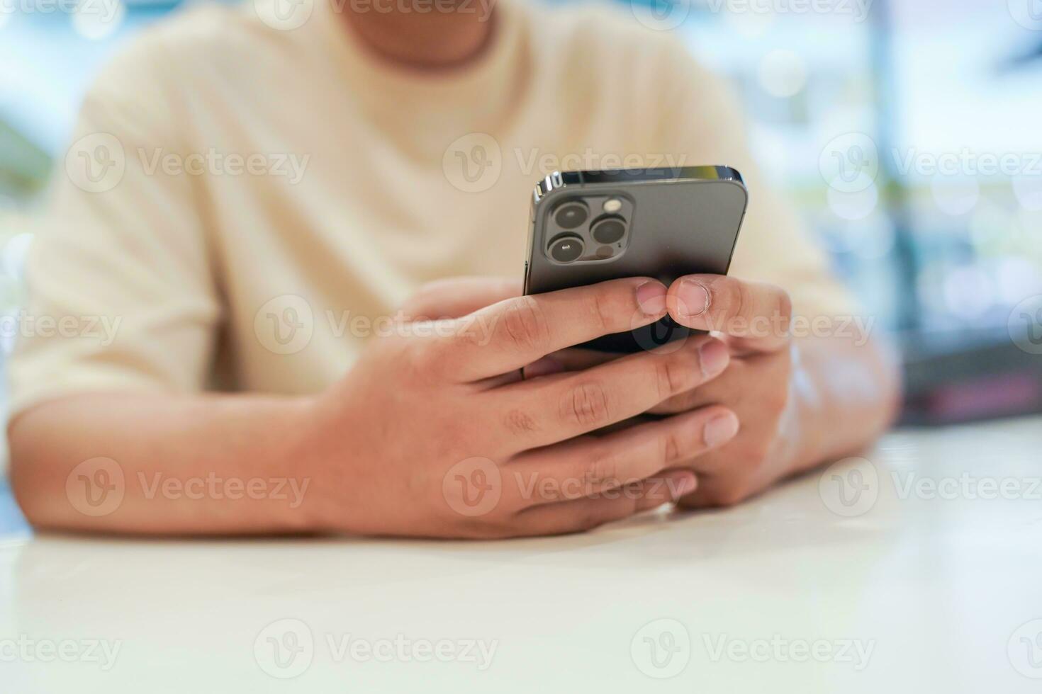 Relaxed young asian man using smart phone  spending time checking news social media. photo