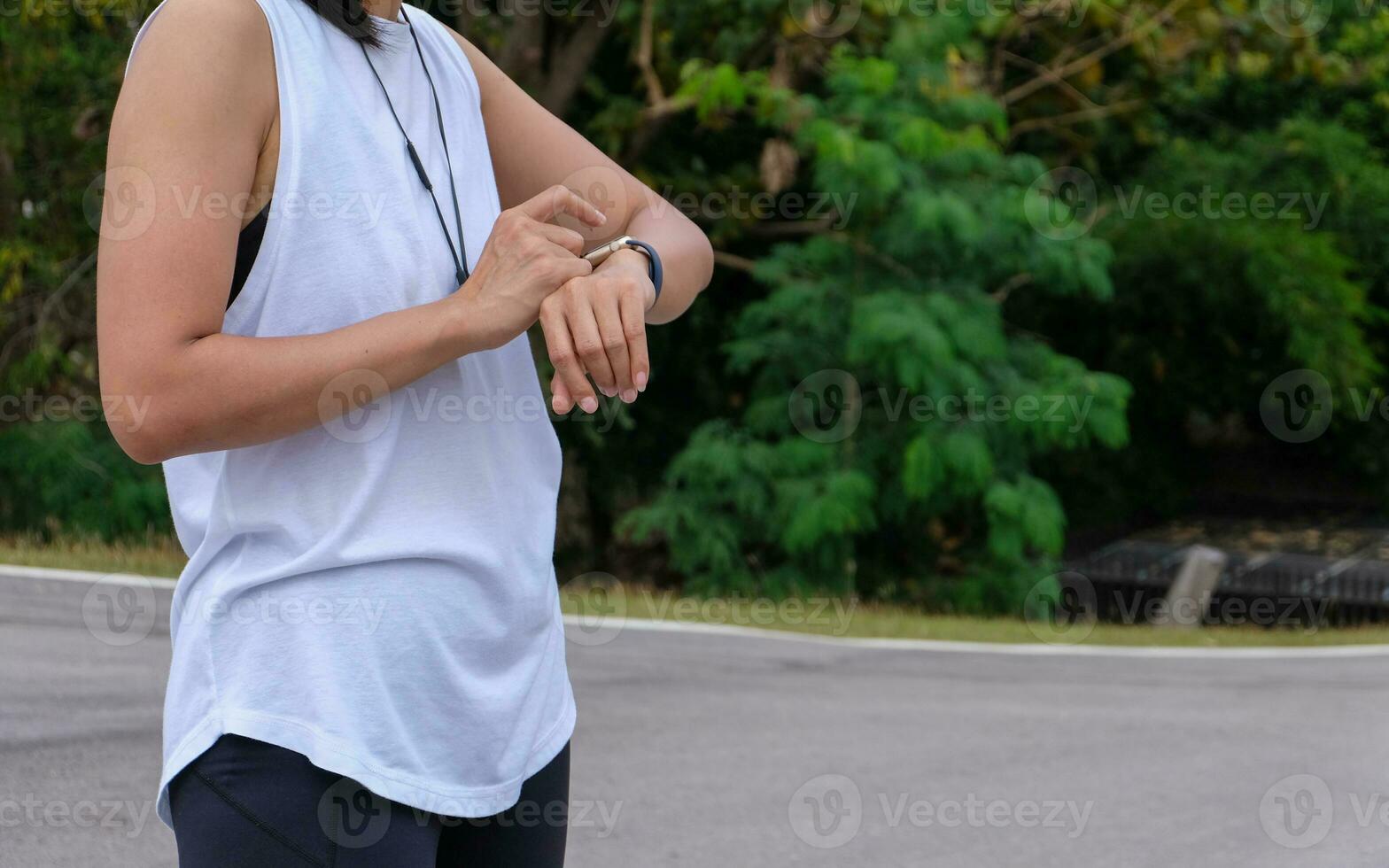 woman measuring smart watch with heart rate after running, health apps concept. photo