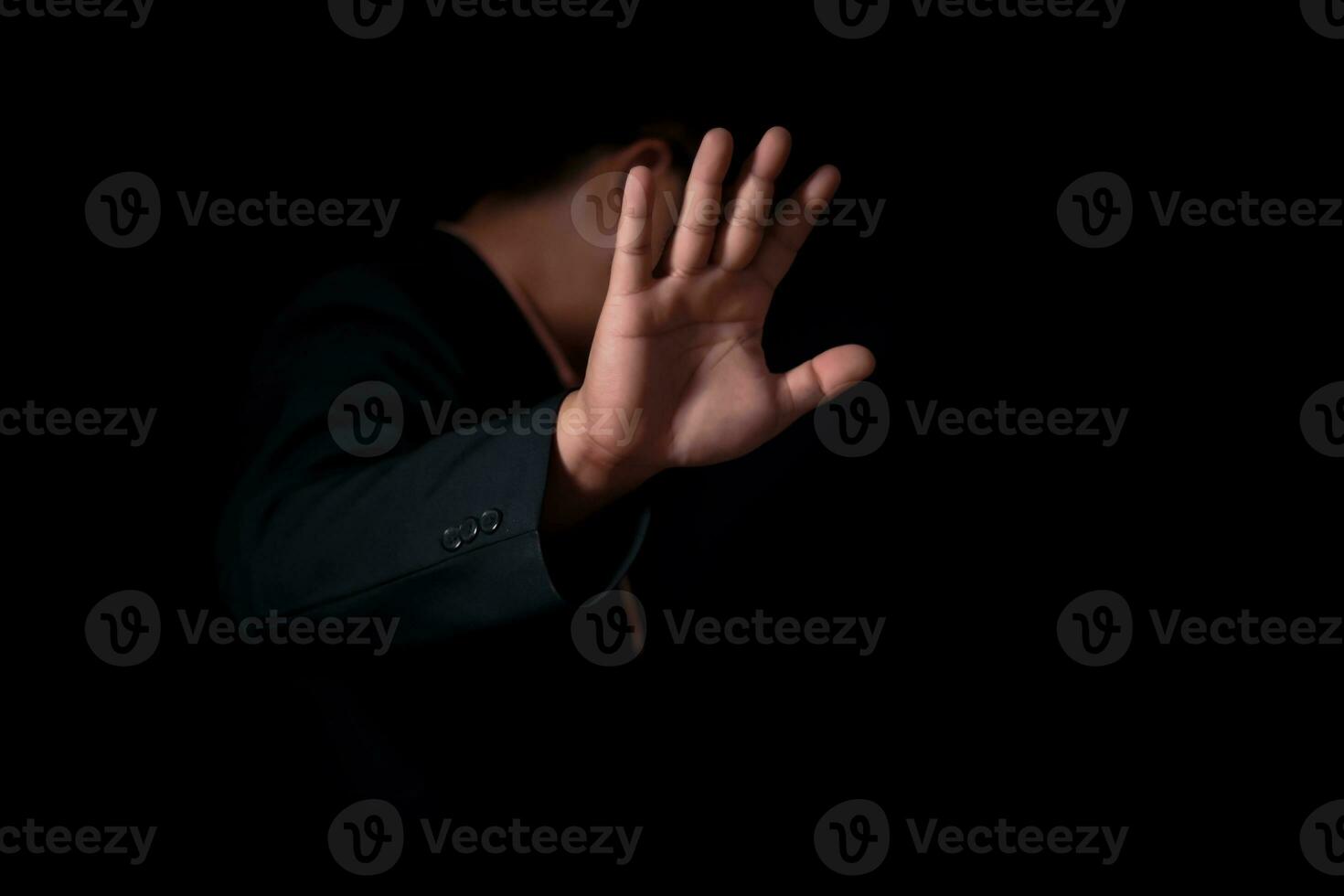 Businessman refusing to take bribe on black background, The businessman says no. , An empty workpiece. Gesture stop. photo